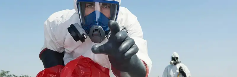 sewage clean up technician wearing protective gear handling biohazard materials in Aurora, CO