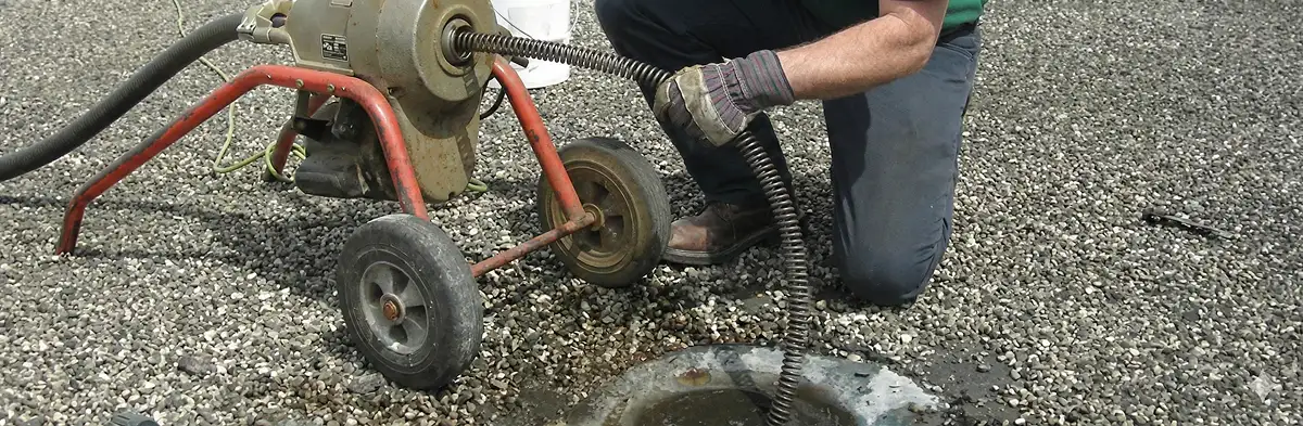 sewer rodding technician actively removing blockages from a sewer line in Aurora, CO